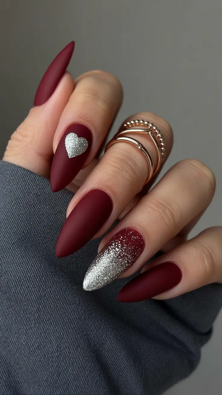 February nails designs 2026 Matte Burgundy With a Silver Heart Accent