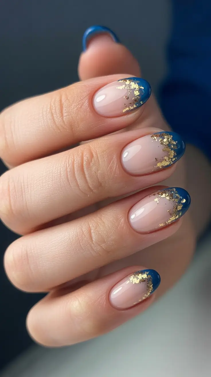 chic pretty spring nails design 2026 Soft nude base with sapphire French and gold foil scatter