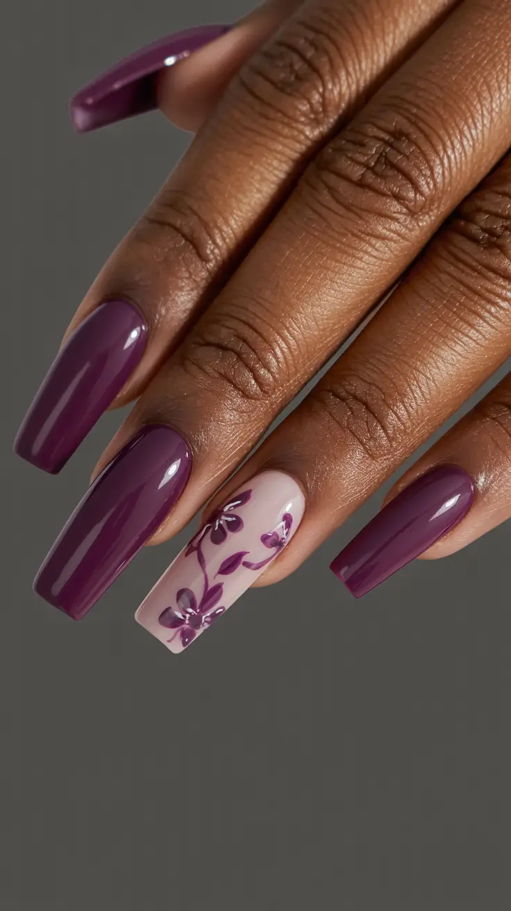 stylish spring nails for dark skin 2026 Deep Plum Gloss with Minimal Floral Accent