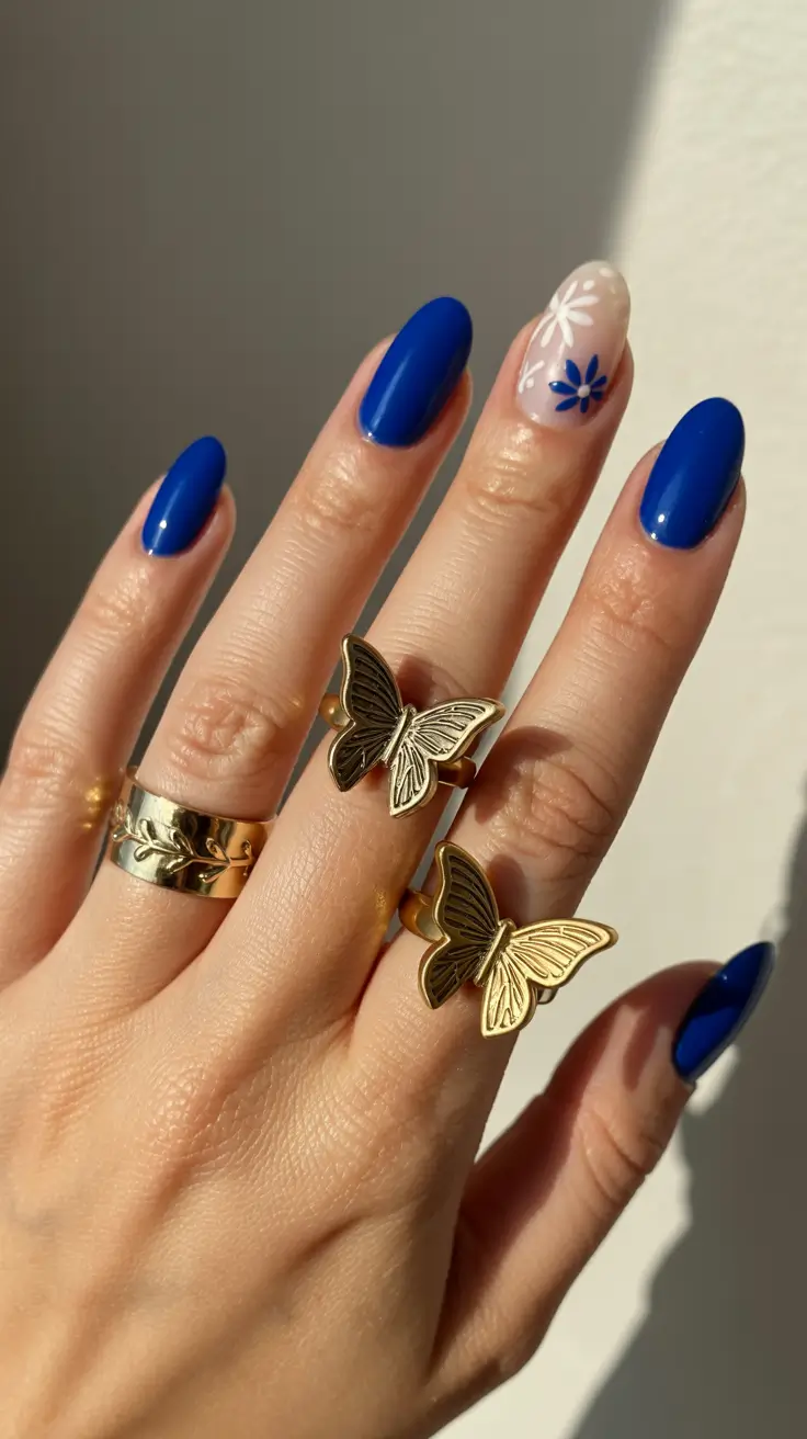 stylish spring oval nails 2026 Cobalt Blue Oval with Minimal Floral Accent