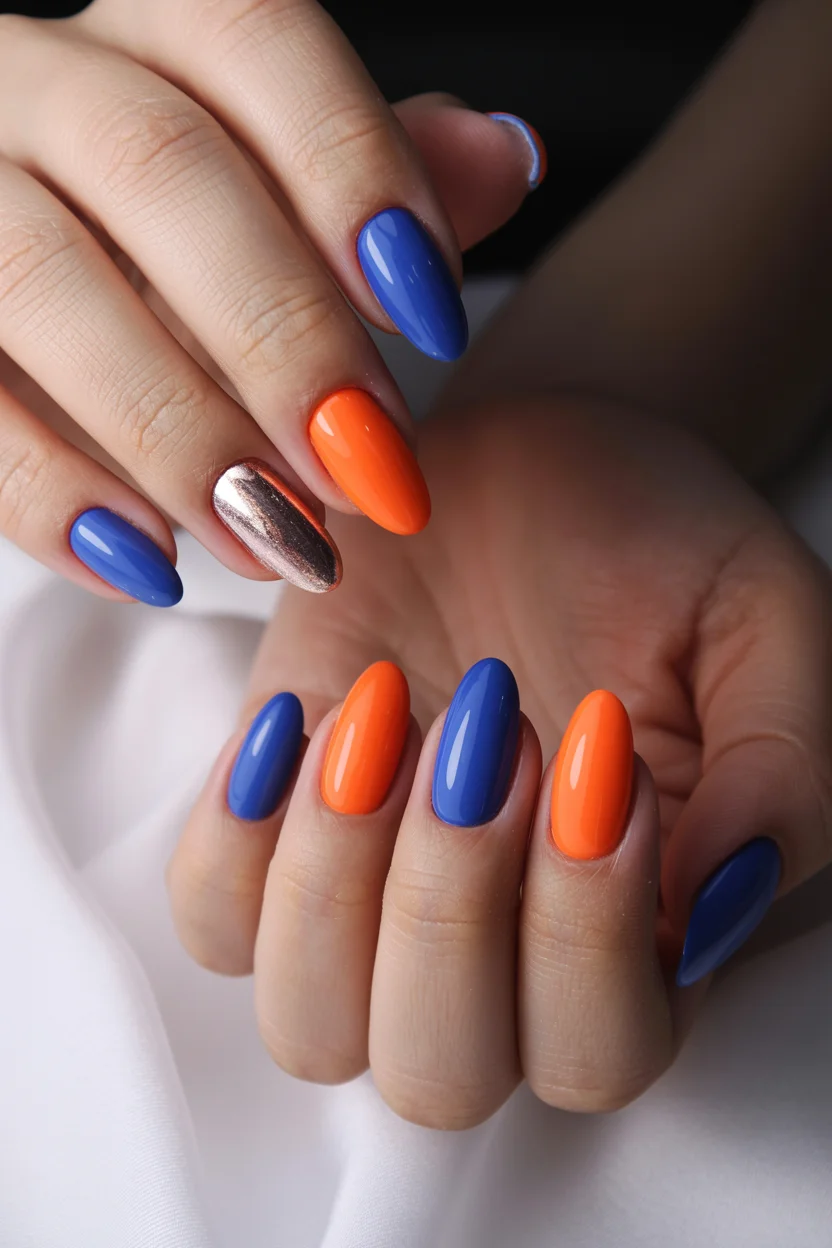 trendy summer nails 2026 Bold Blue And Orange Nails With Metallic Accent Drama