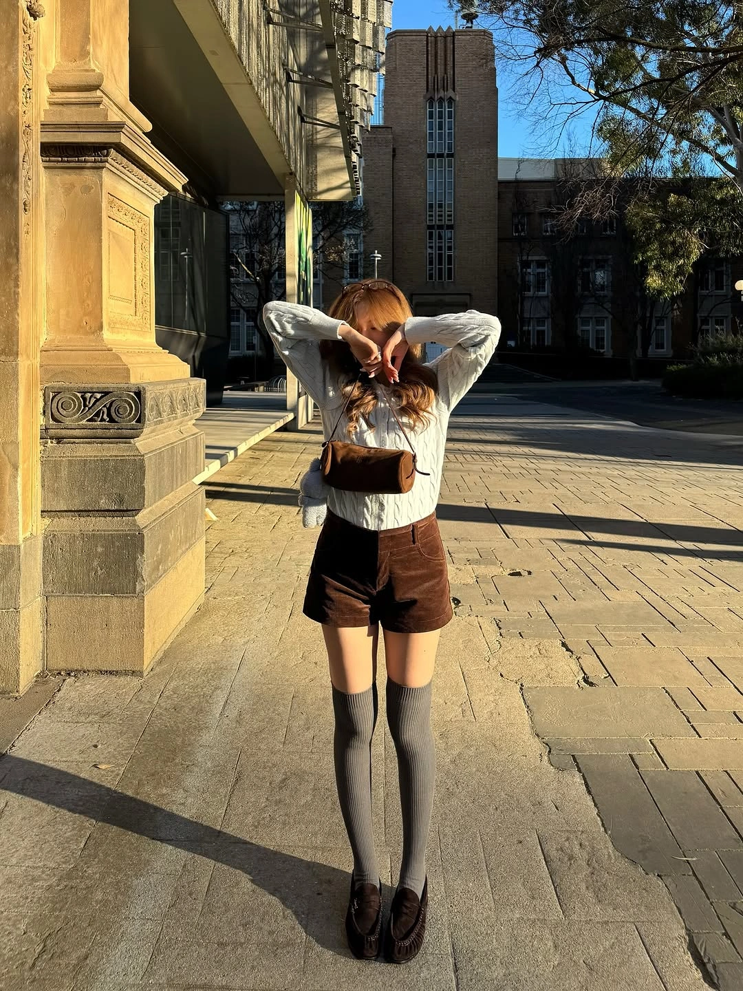 early fall outfits 2026 Cable Knit Sweater and Tailored Shorts for the First Crisp Mornings