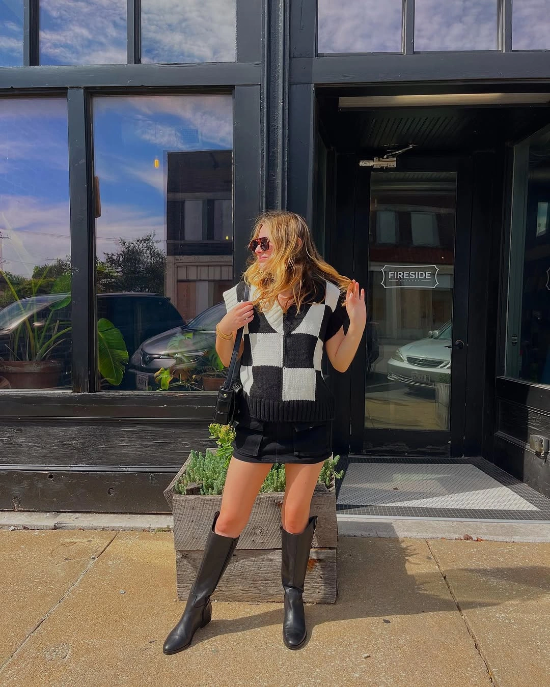 early fall outfits 2026 Checkerboard Sweater Vest and Tall Boots for Playful Fall Layering