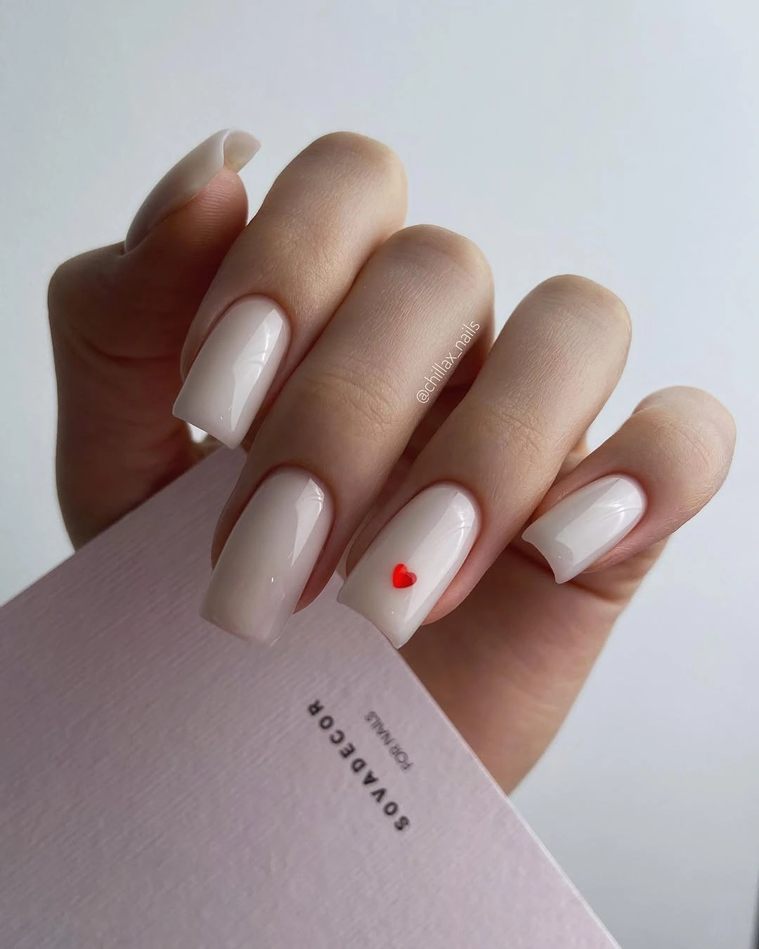 august nails color 2026 Minimal White Nails with a Tiny Red Heart Accent