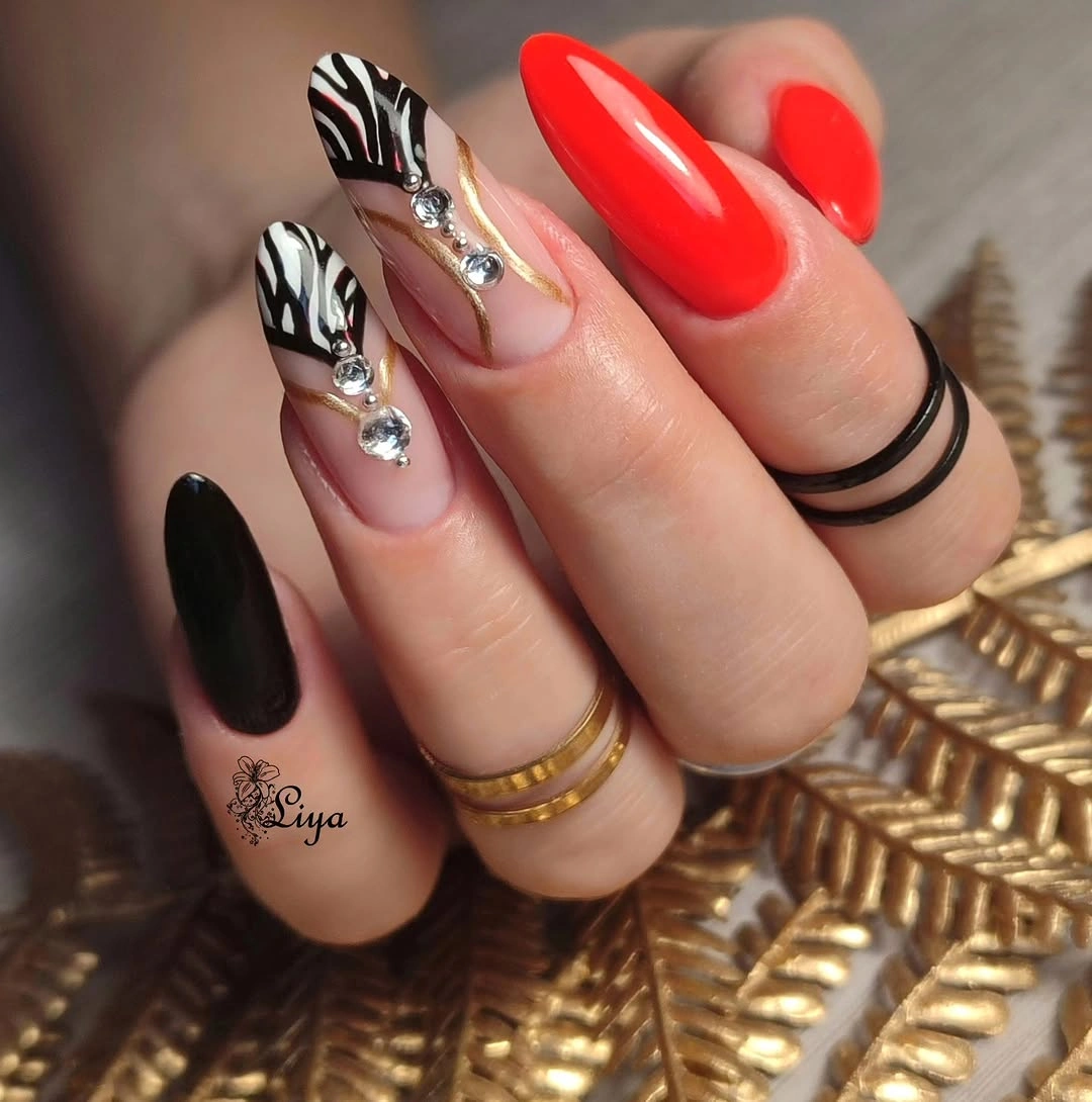 august nails ideas 2026 Bold Zebra Glam With Vibrant Red Accents