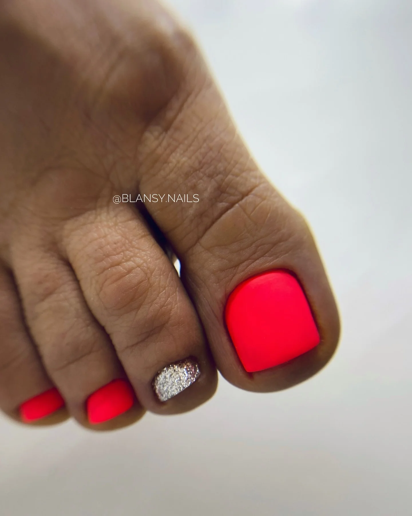august pedicure nails ideas 2026 Neon Coral with a Touch of Silver Glam