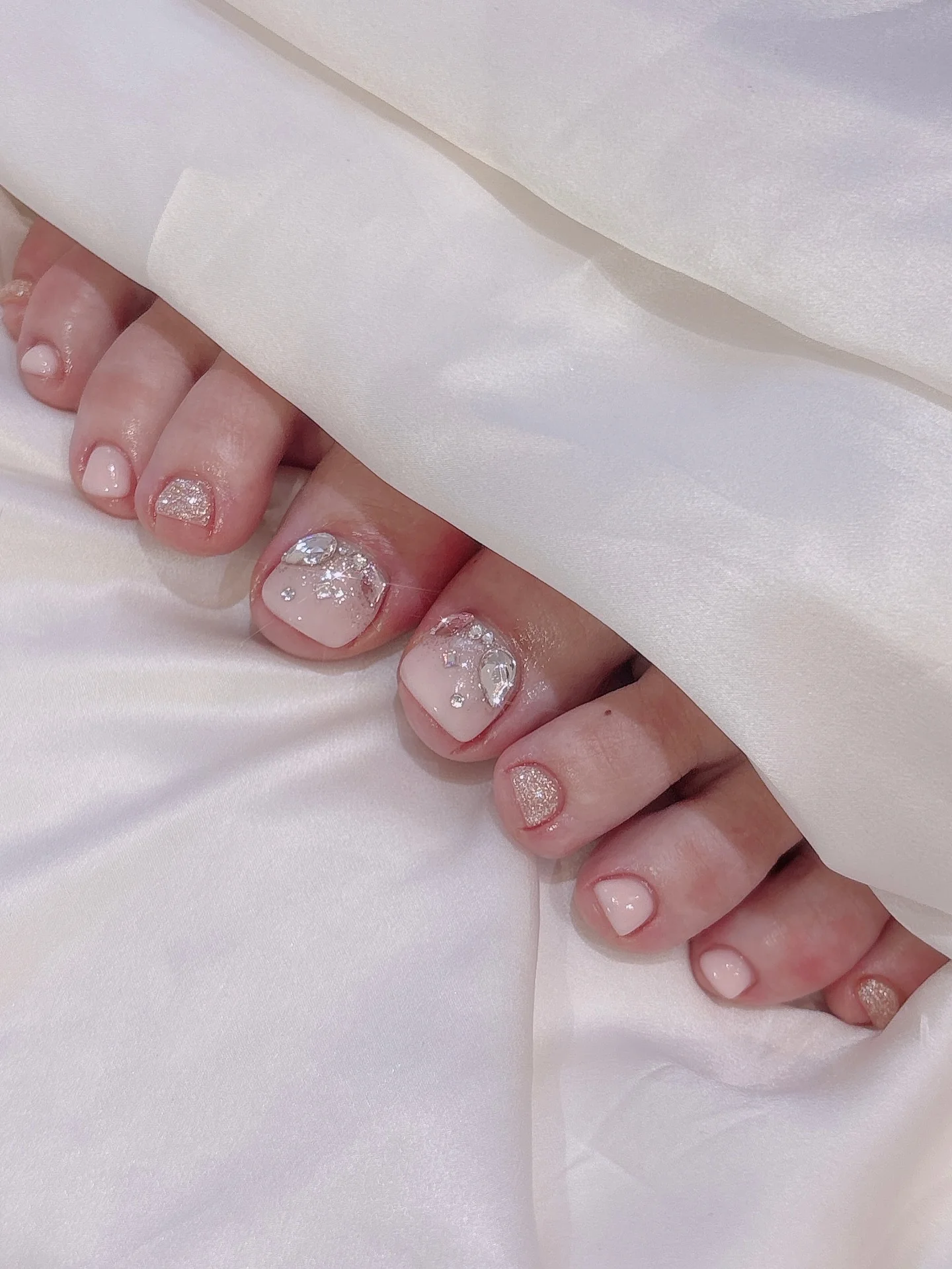 august toe nails 2026 Crystal Embellished Blush Pedicure for Special Occasions