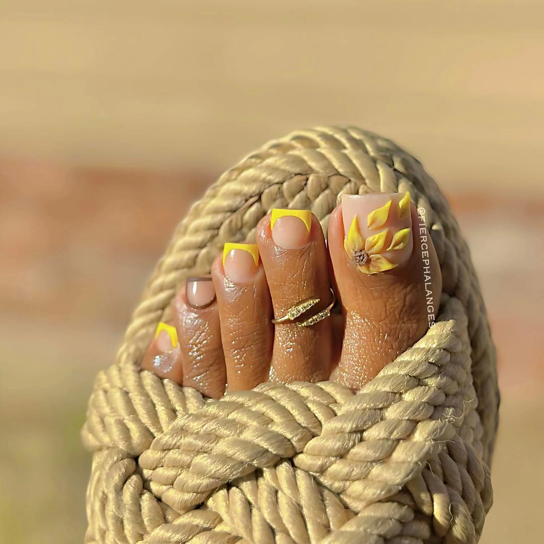 august toe nails 2026 Sunny Yellow French Pedicure with Sculpted Floral Art