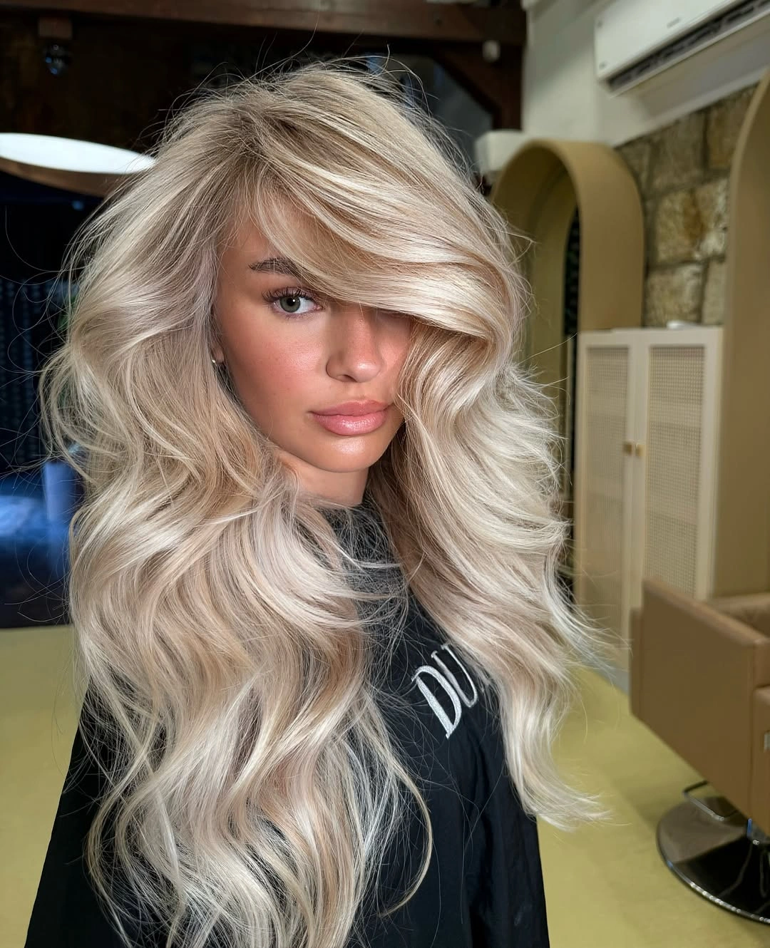 body waves hairstyle Voluminous Platinum Blonde Waves With Feathered Layers