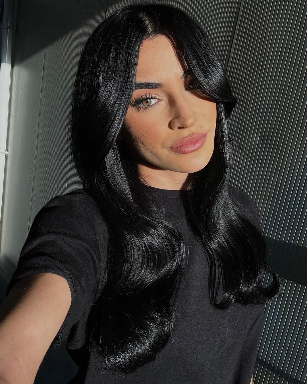 body waves hairstyle Jet Black Waves With a Glossy Center Part