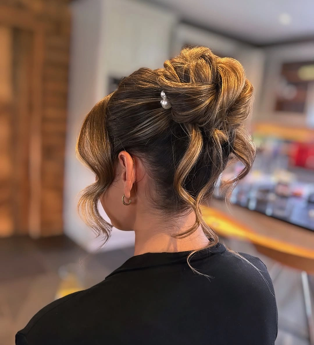 bridesmaid hairstyling Modern Sculpted Bun with Soft Face-Framing Layers