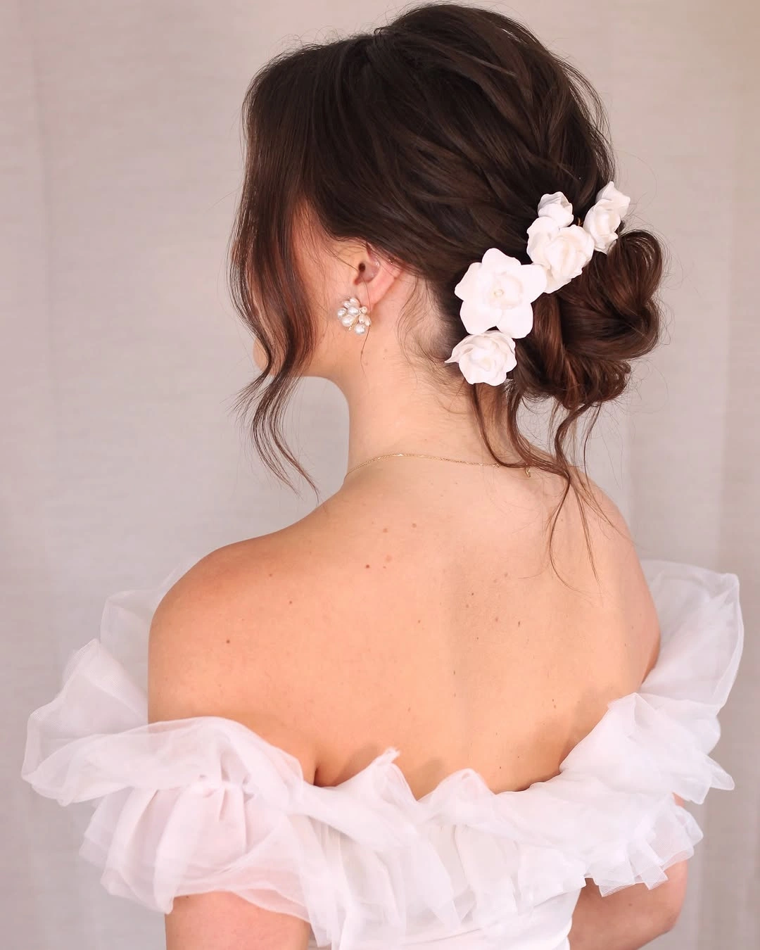 bridesmaid hairstyling Relaxed Bridal-Inspired Bun with Floral Romance
