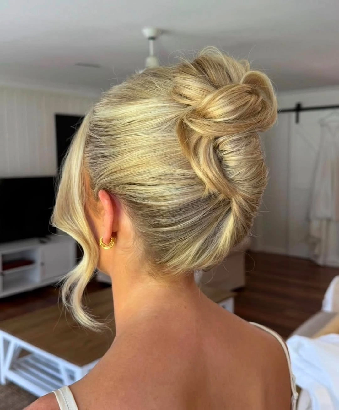 bridesmaid hairstyling Elegant Blonde Twisted Bun with Effortless Shine