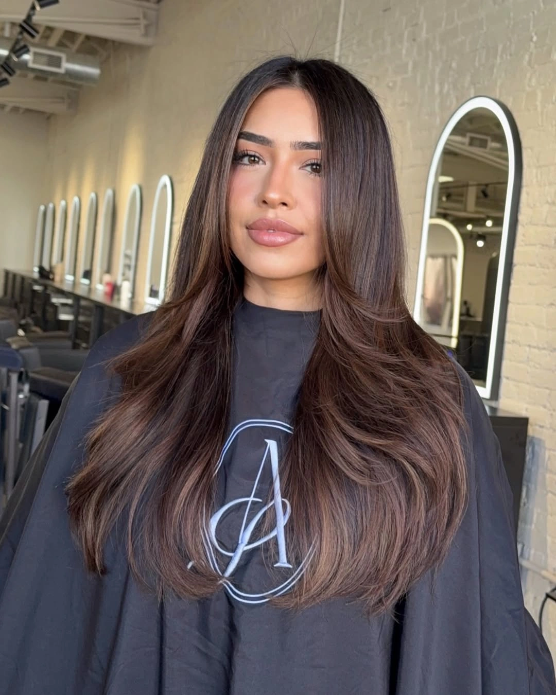 dimensional brunette hair color Center-Part Brunette Layers With Soft Warmth