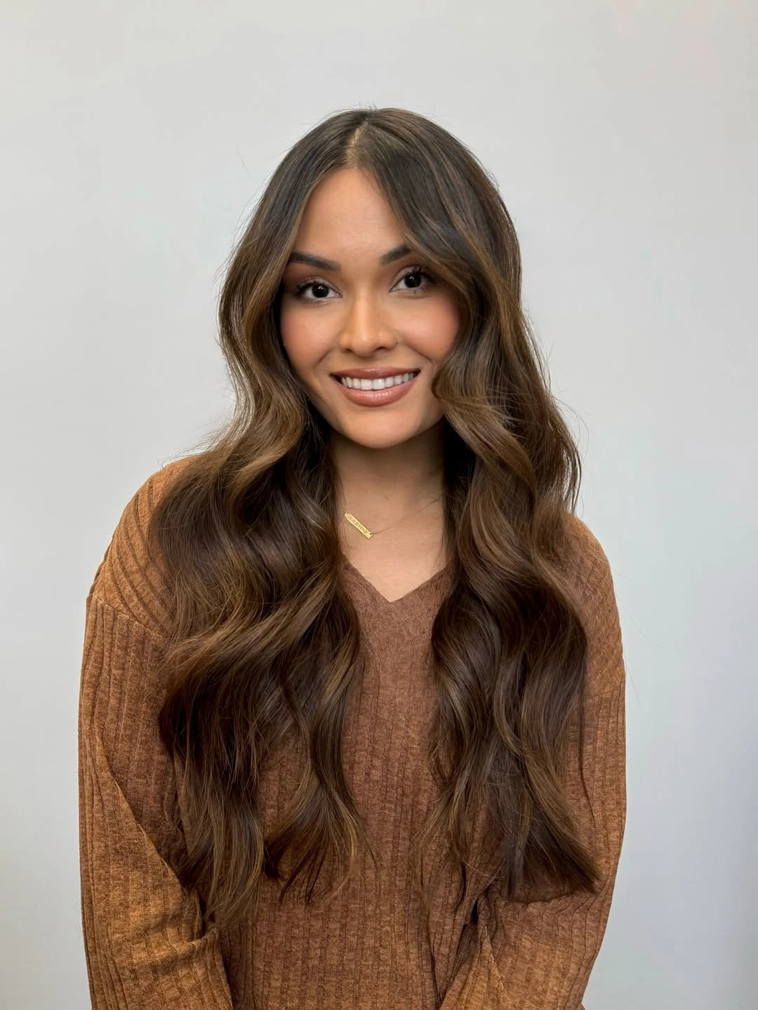 dimensional brunette hair color Soft Brunette Waves With A Warm Center Part