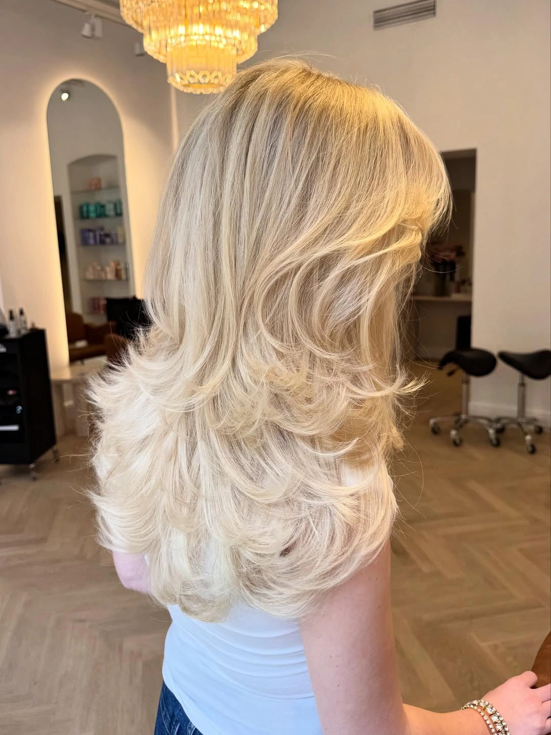 Fall blonde hair colour 2026 Feathered Butter Blonde Layers With Retro Bounce