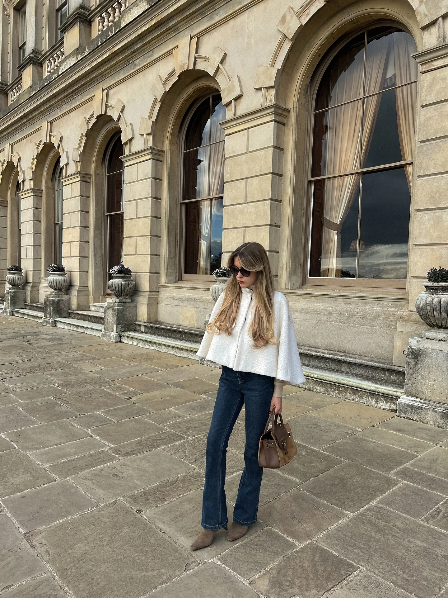 fall classy outfits women 2026 Relaxed Denim and a White Cape for Quiet Luxury Style