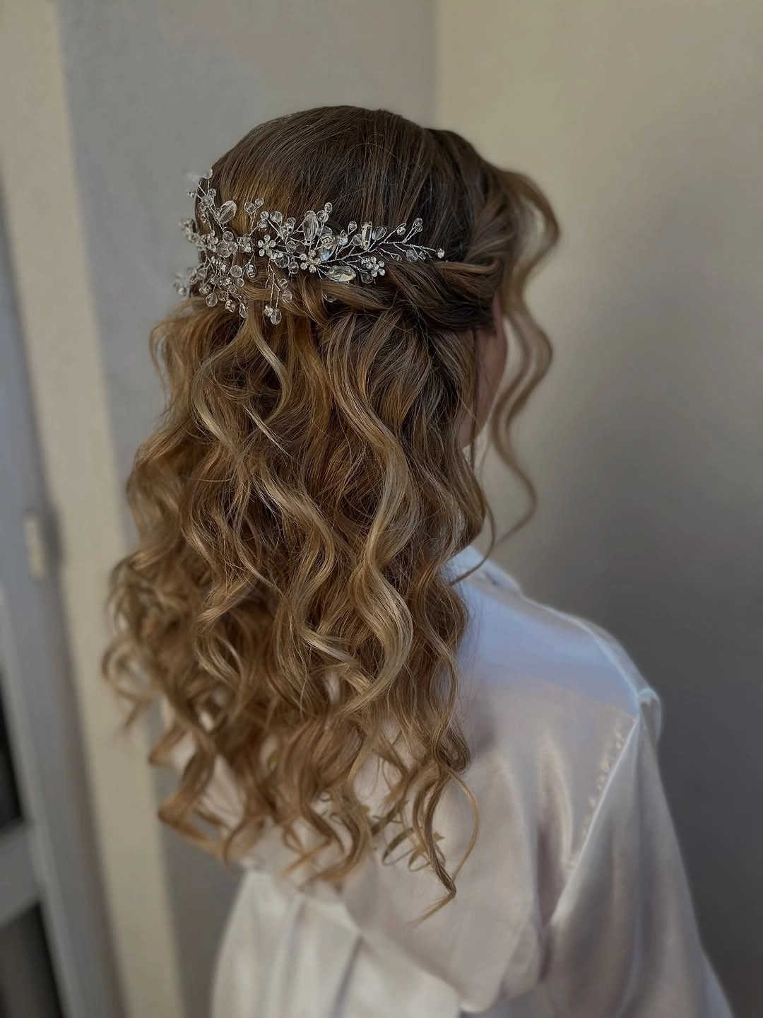 Fall hairstyles for wedding guests 2026 Romantic Crystal Half-Up Waves for an Elegant Evening Wedding