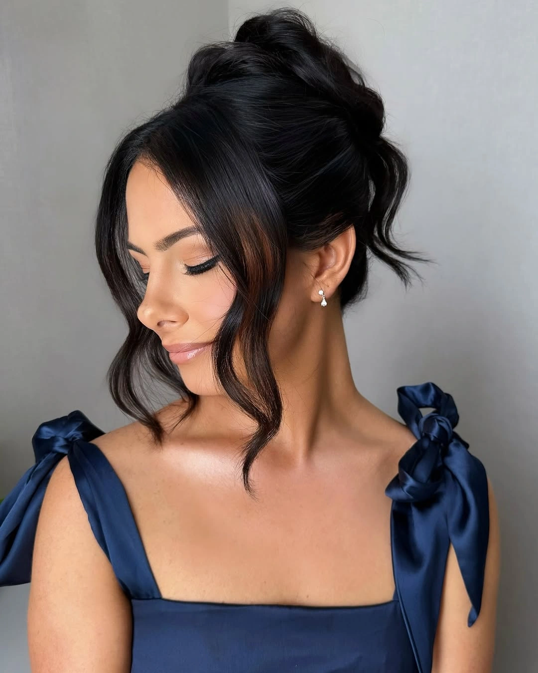 Fall hairstyles for wedding guests 2026 Soft Textured Updo with Elegant Face-Framing Waves