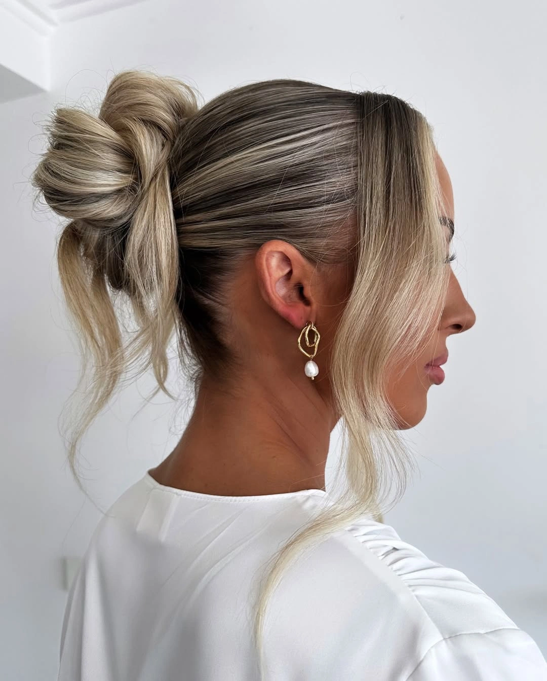 Fall hairstyles for wedding guests 2026 Modern Sleek Bow Bun That Looks Chic Without Trying Too Hard