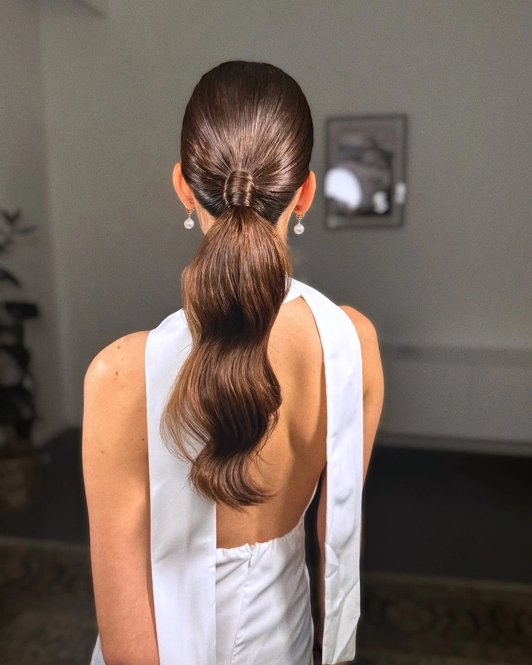 Fall hairstyles for wedding guests 2026 Sleek Wrapped Ponytail with Contemporary Elegance