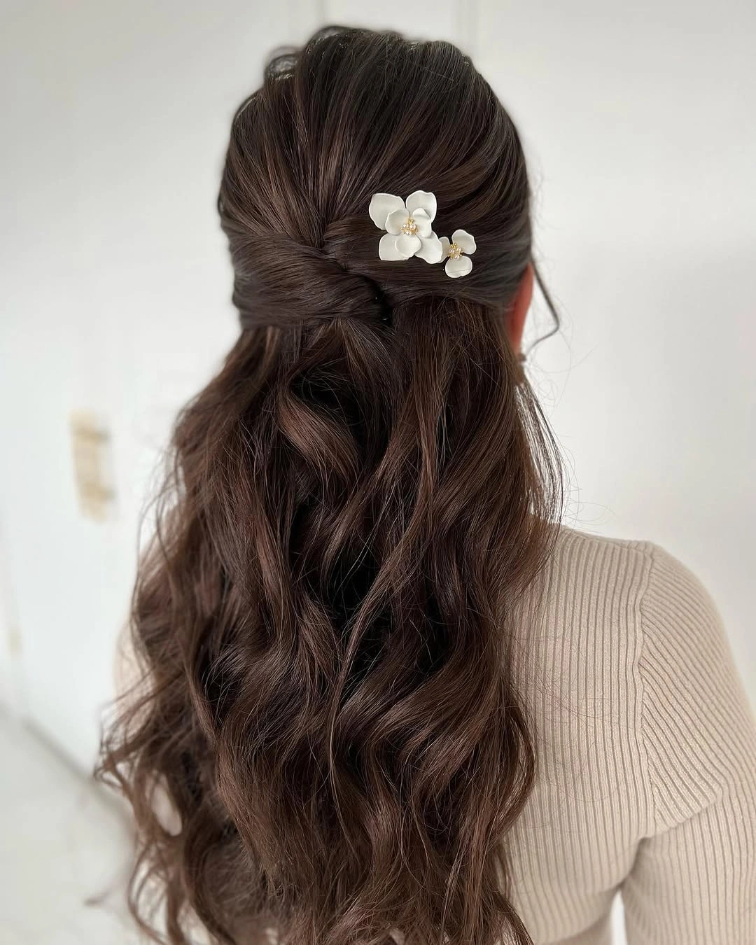 Fall hairstyles for wedding guests 2026 Elegant Half-Up Waves with Delicate Floral Accents