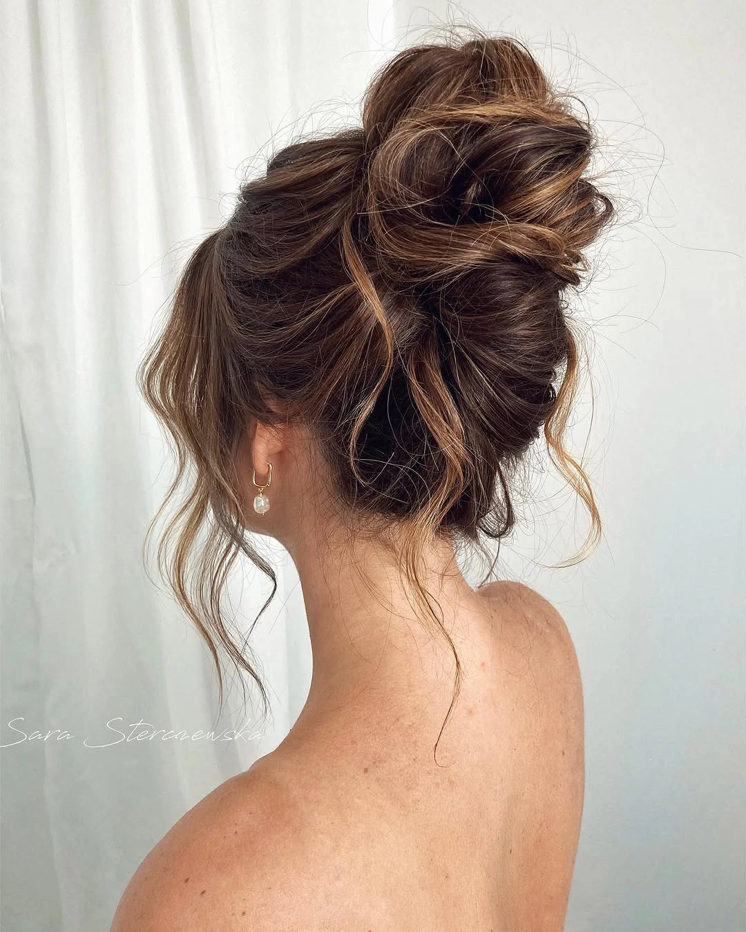 Fall hairstyles for wedding guests 2026 Relaxed Textured Updo with Face-Framing Pieces