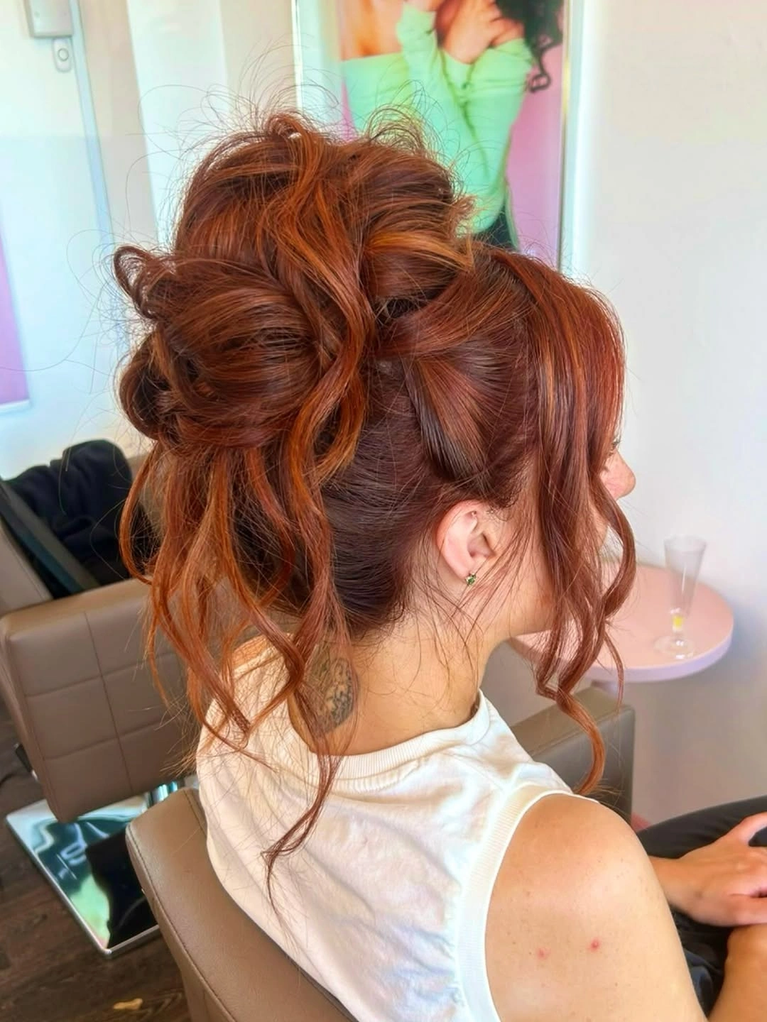 Fall hairstyles for wedding guests 2026 Voluminous Copper Updo with Soft Face-Framing Tendrils