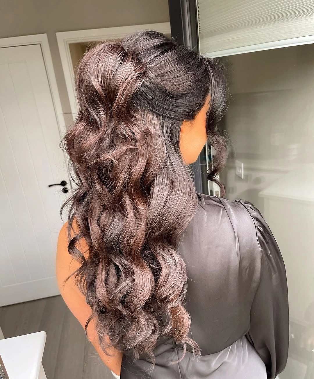 Fall hairstyles for wedding guests 2026 Glossy Brunette Half-Up Waves with Modern Romance