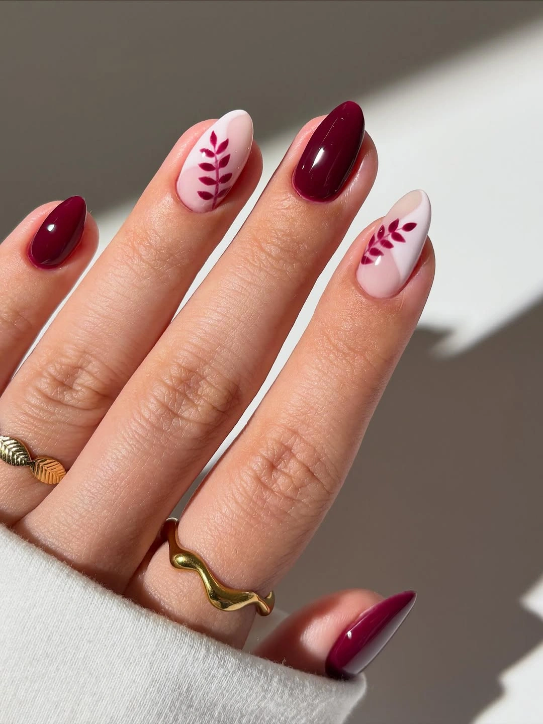 Fall manicure 2026 Burgundy Nails With Cream Leaf Accents