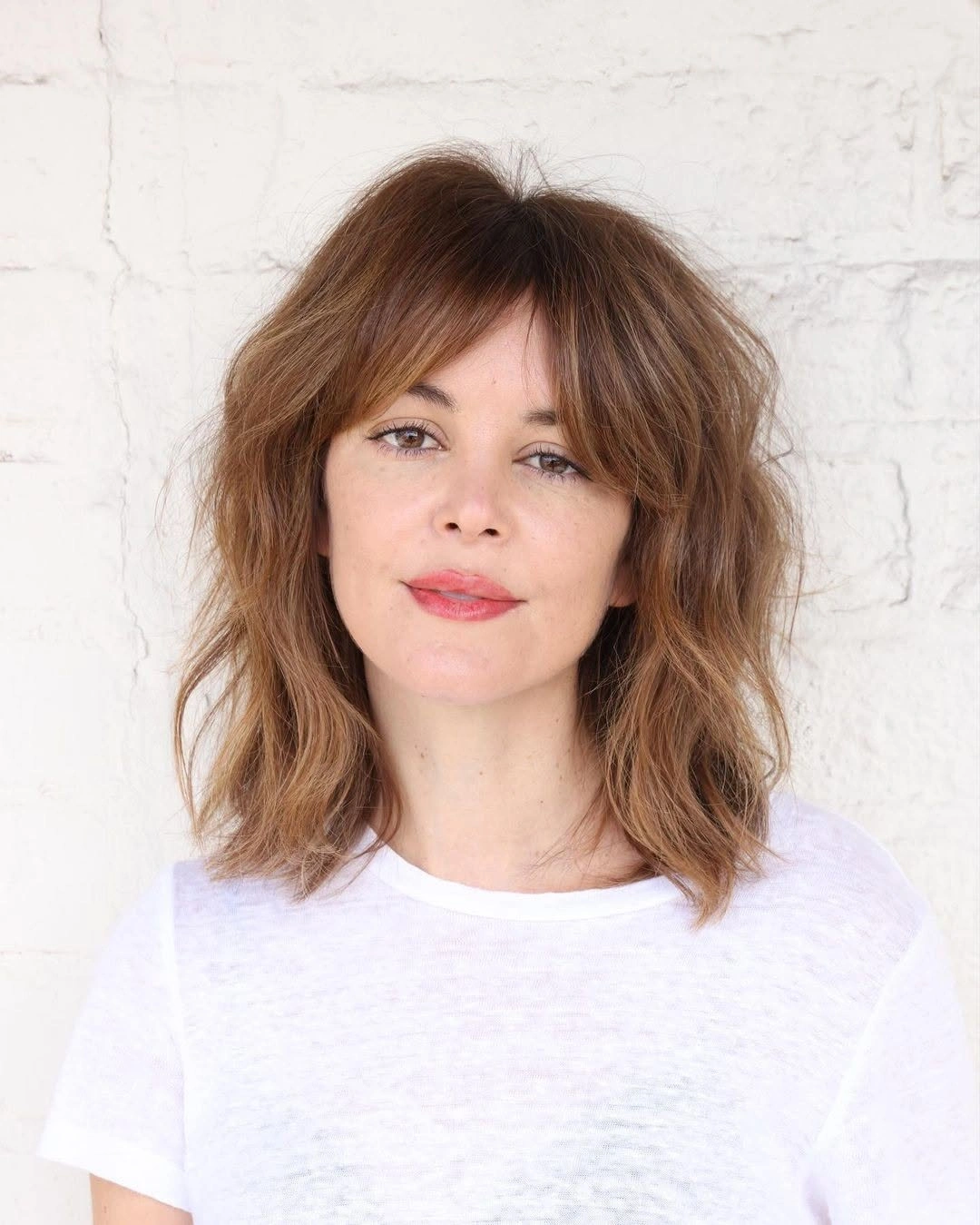 fall medium haircuts 2026 Relaxed French-Inspired Wavy Bob