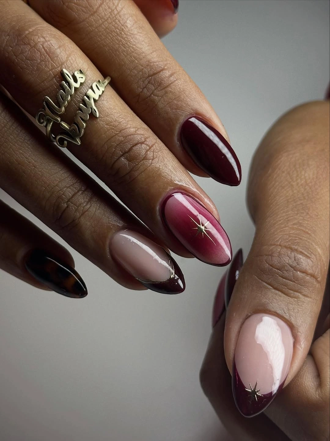 Fall short nails 2026 Burgundy Almond Nails With Pale Pink Curves