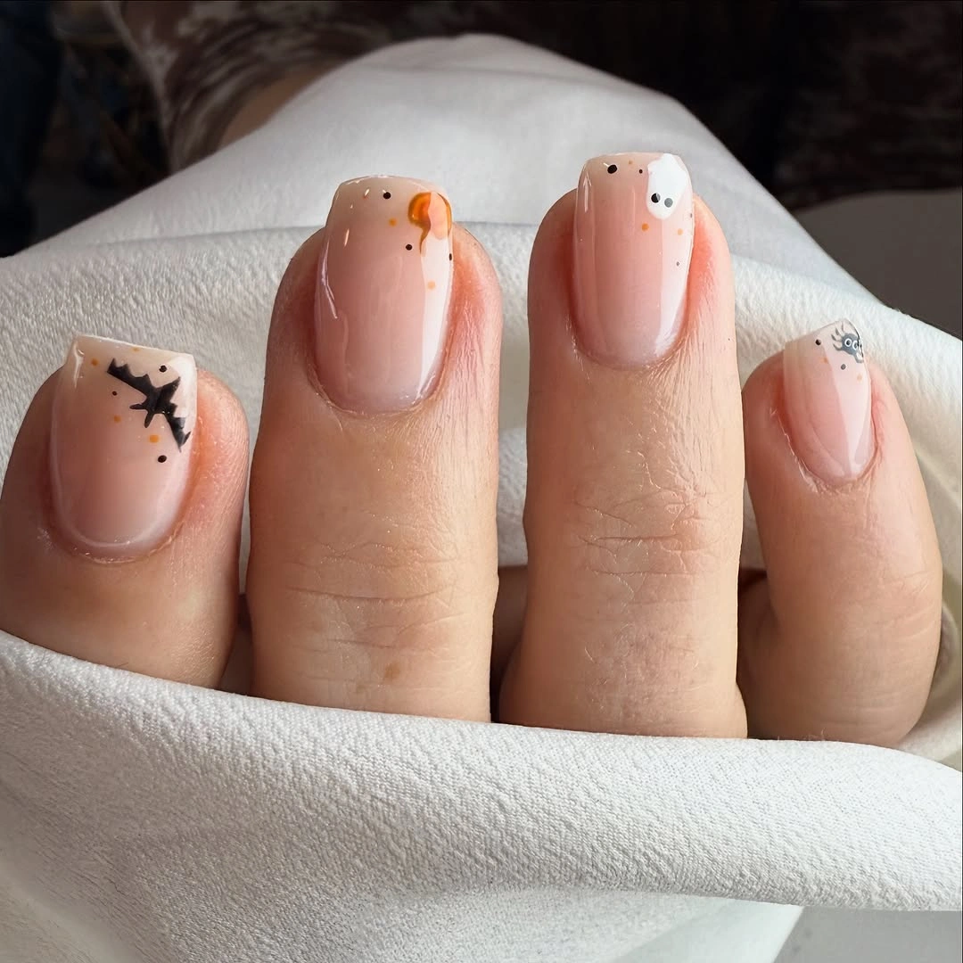 Fall short nails 2026 Soft Peach Nails With Tiny Ghost Accents