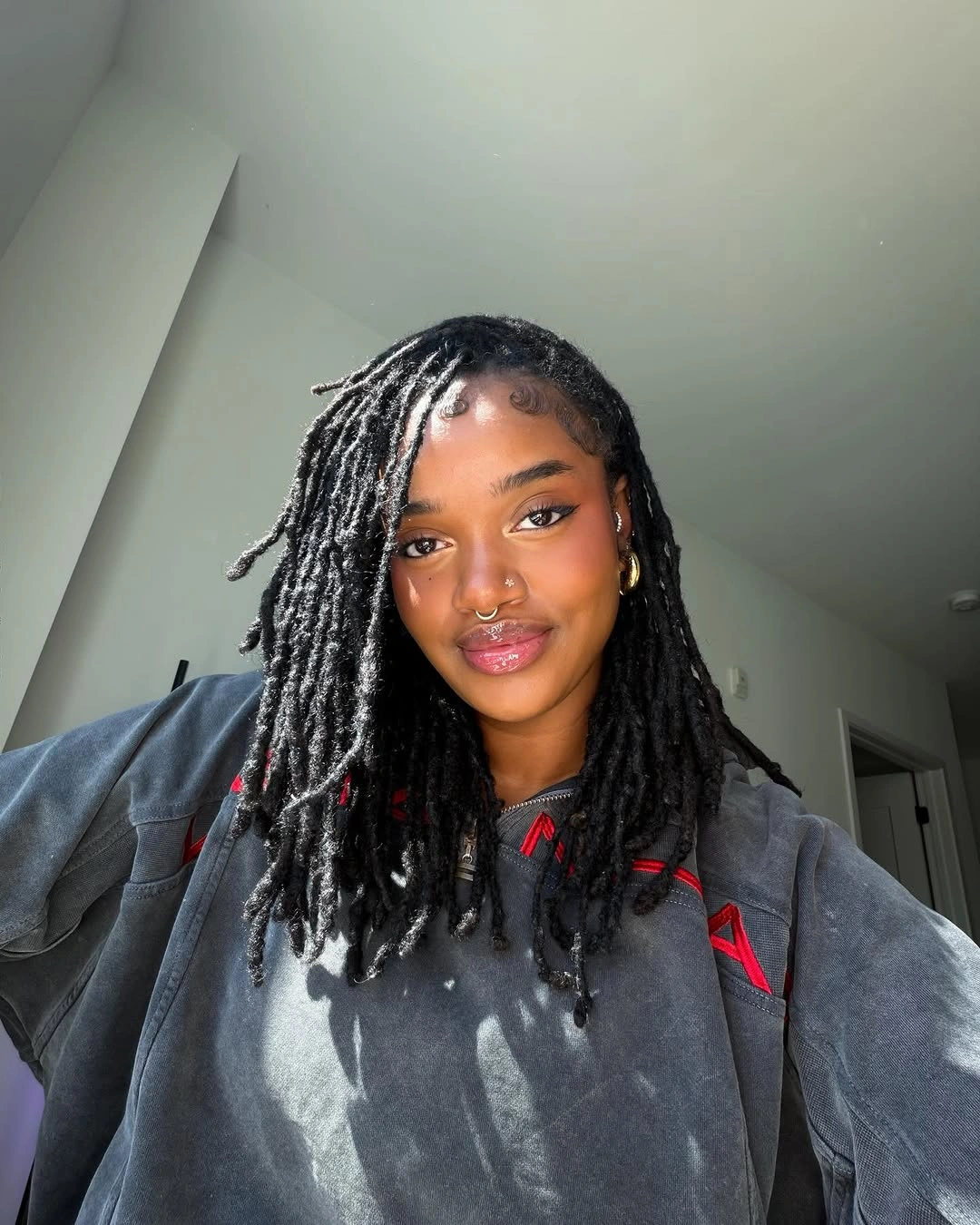 locs hairstyles for black women Classic Shoulder-Length Black Locs with Side Part