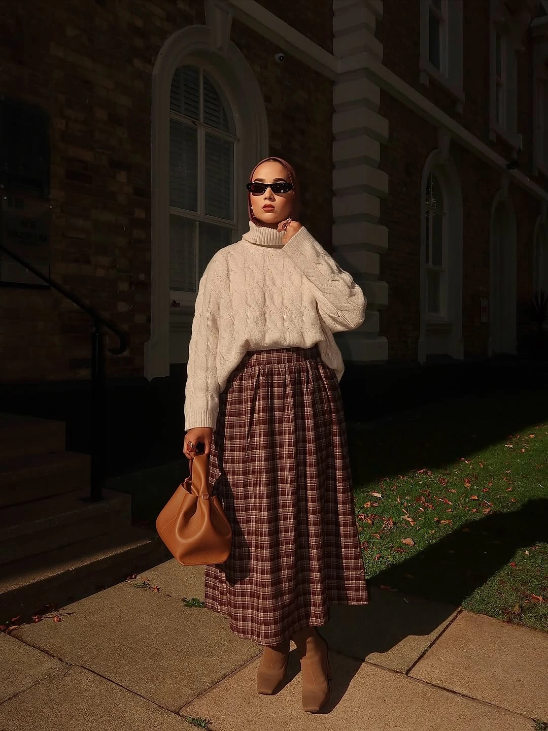 modest fall outfits 2026 Cozy Cable Knit Meets a Timeless Plaid Skirt