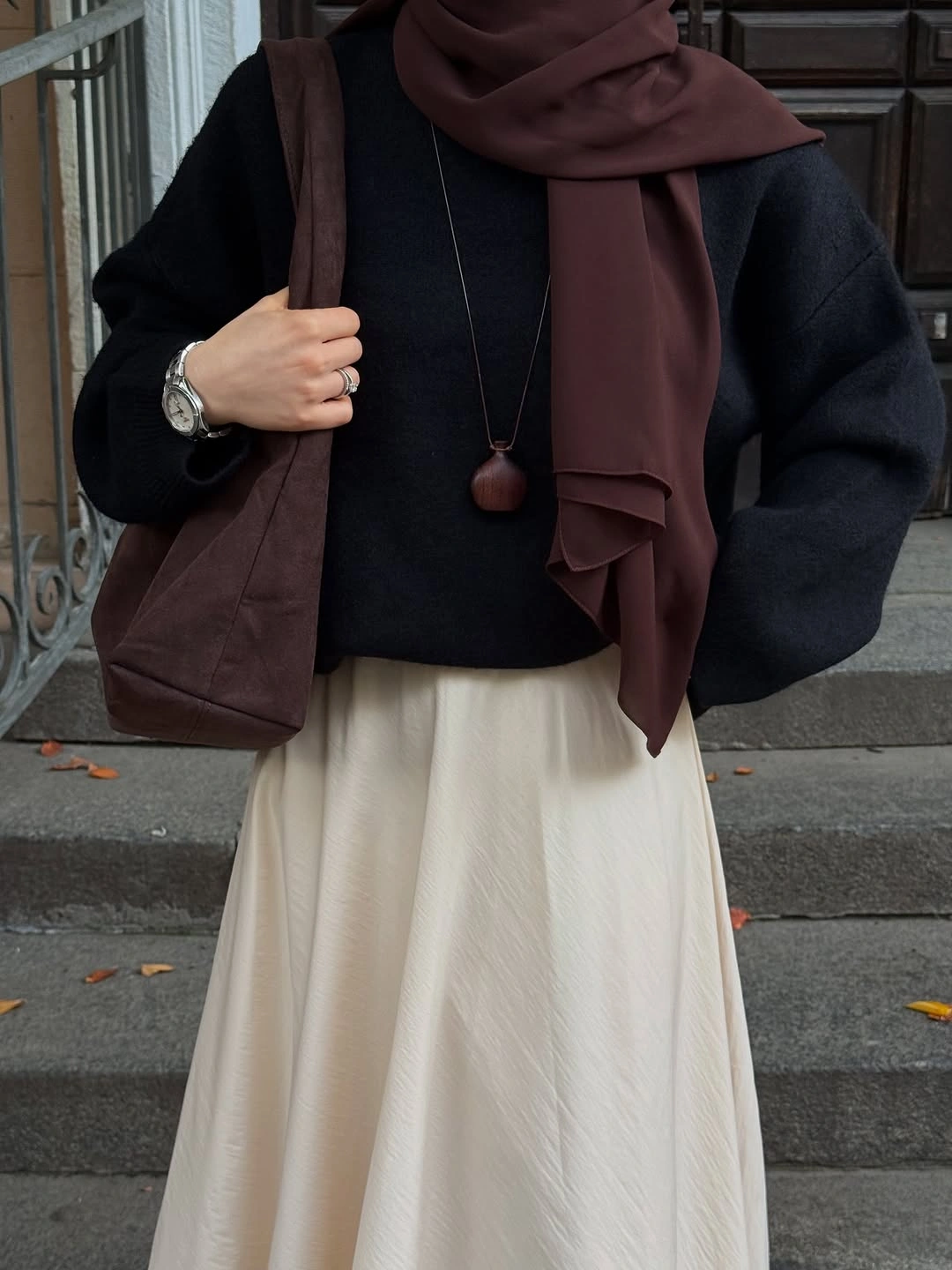 September fashion trends 2026 Brown Scarf With Cream Skirt And Dark Coat
