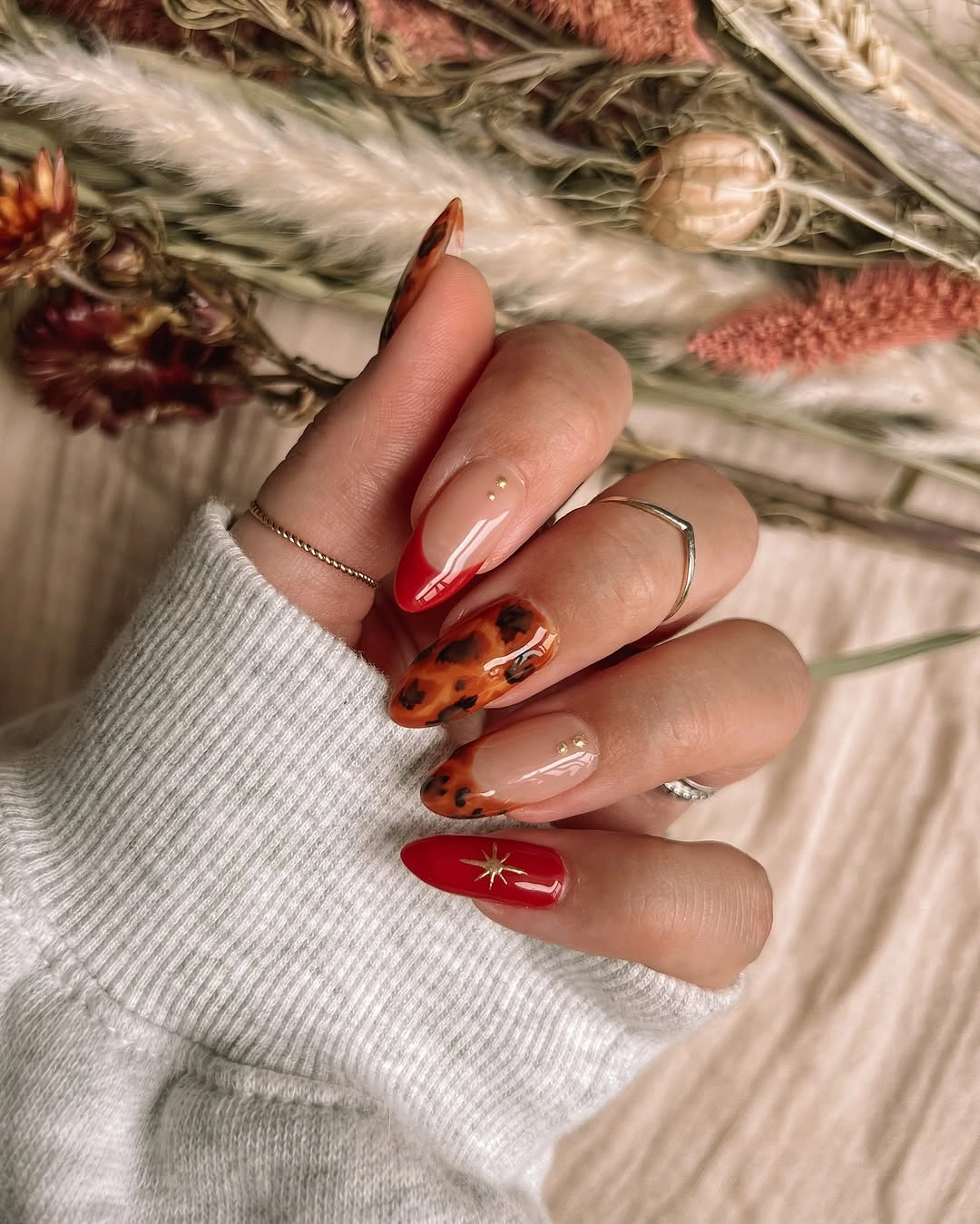September nail art ideas 2026 Copper Swirls and Star Accents on Almond Nails