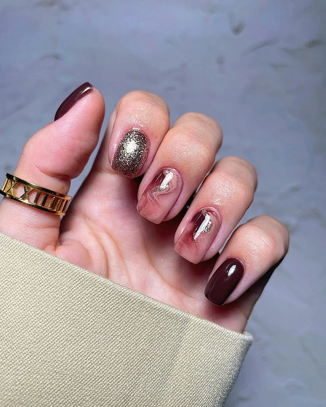 September nail designs 2026 Chocolate Burgundy Nails With Metallic Swirls