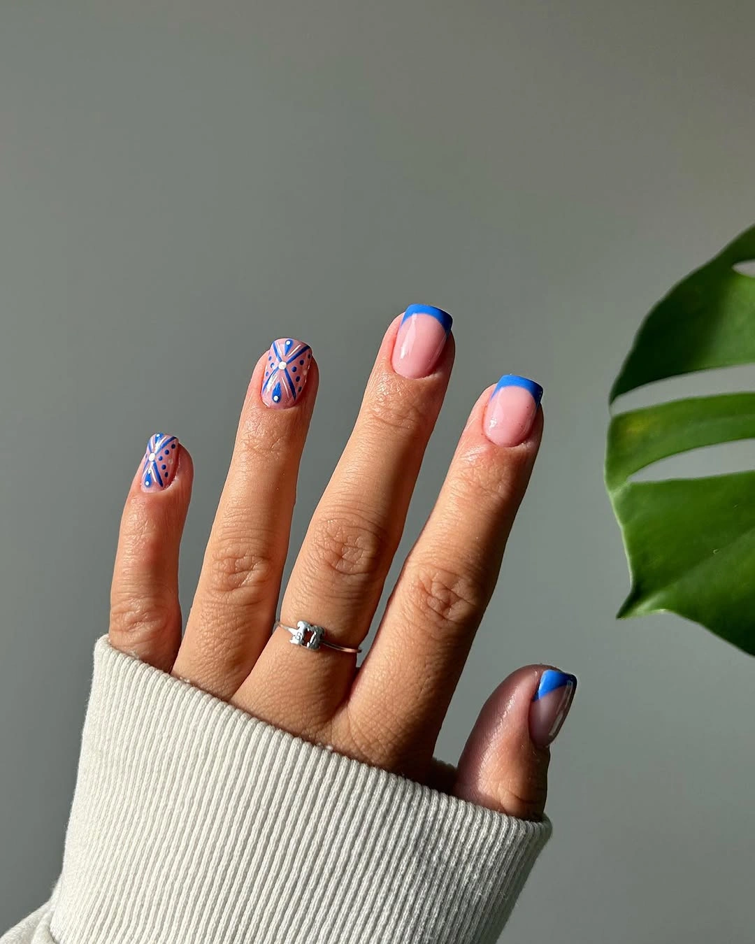 September nail designs 2026 Blue French Tips With Delicate Floral Art