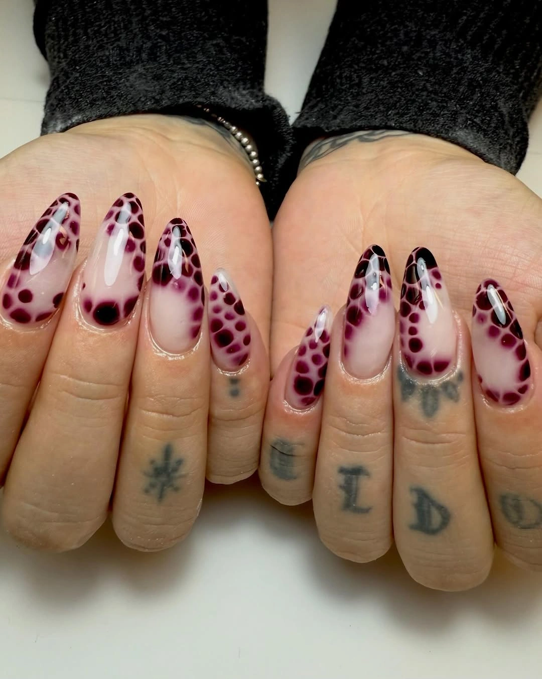 September nails color 2026 Burgundy Dotted Almond Edges On A Nude Base