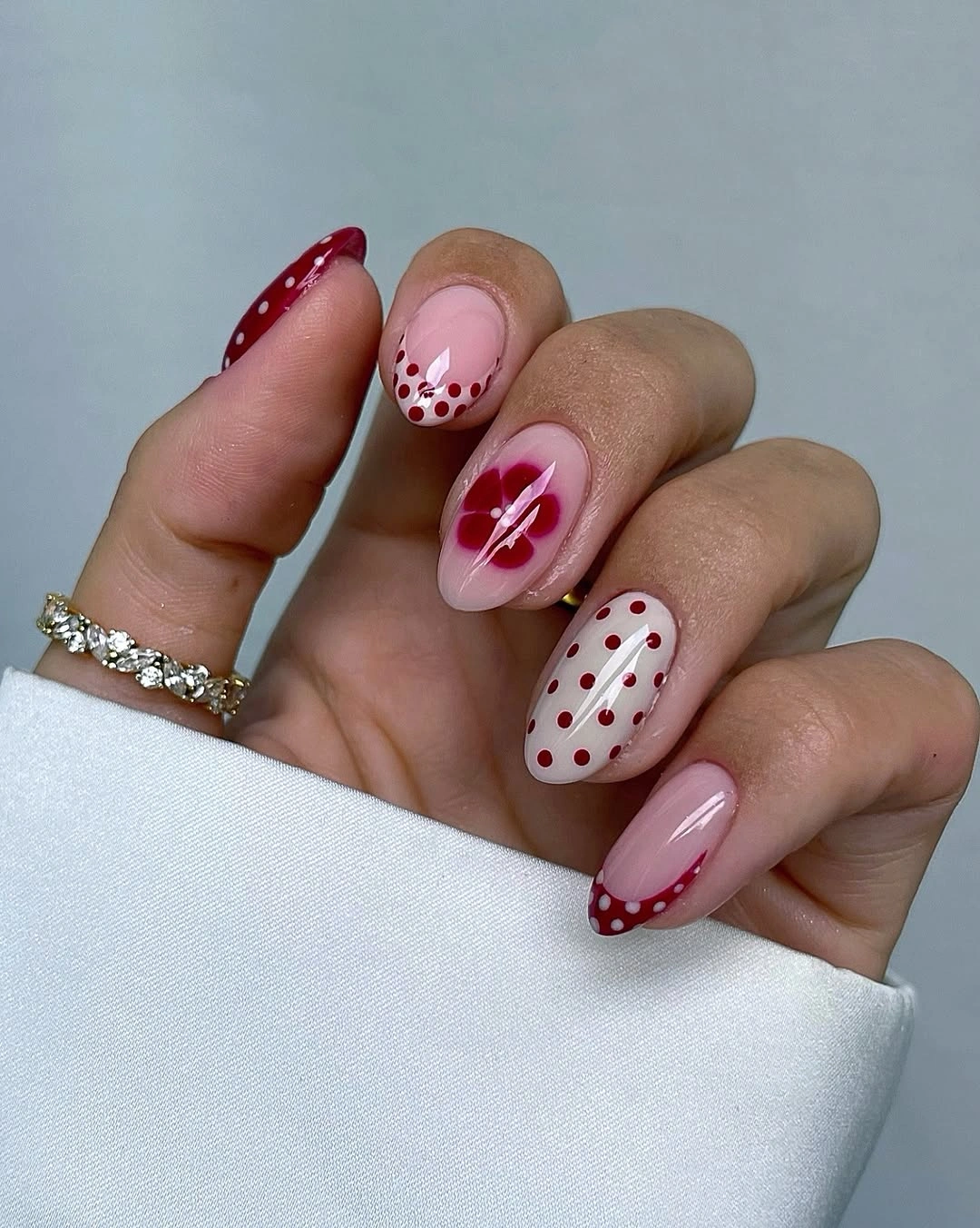 September nails color 2026 Red Polka Dots And Floral Almond Accents