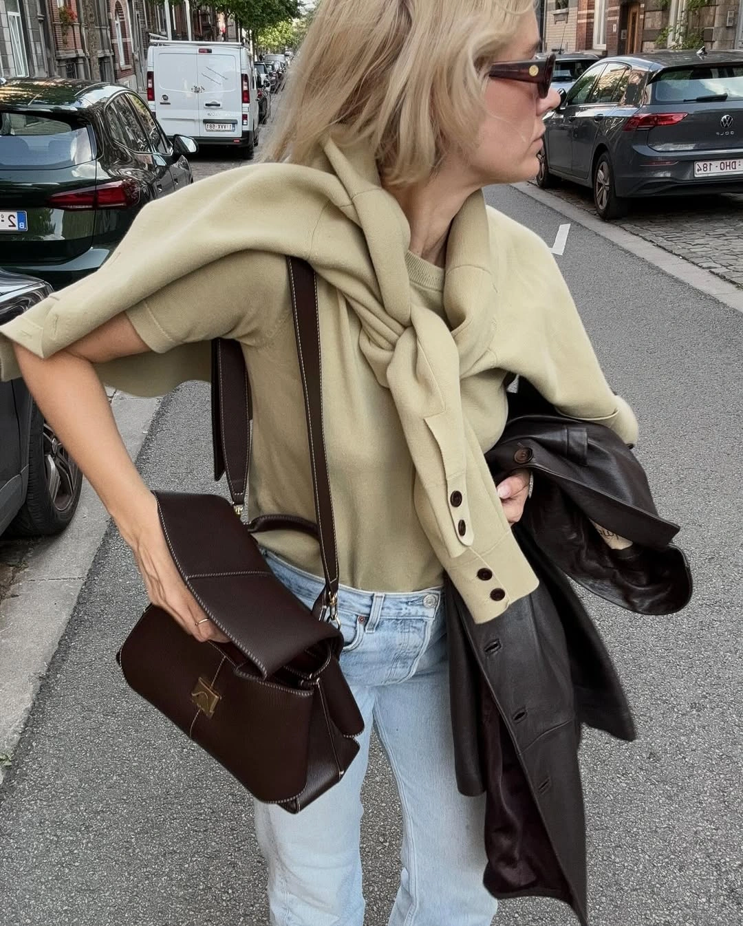 September outfits ideas 2026 Sweater-Draped Neutrals With Pale Denim