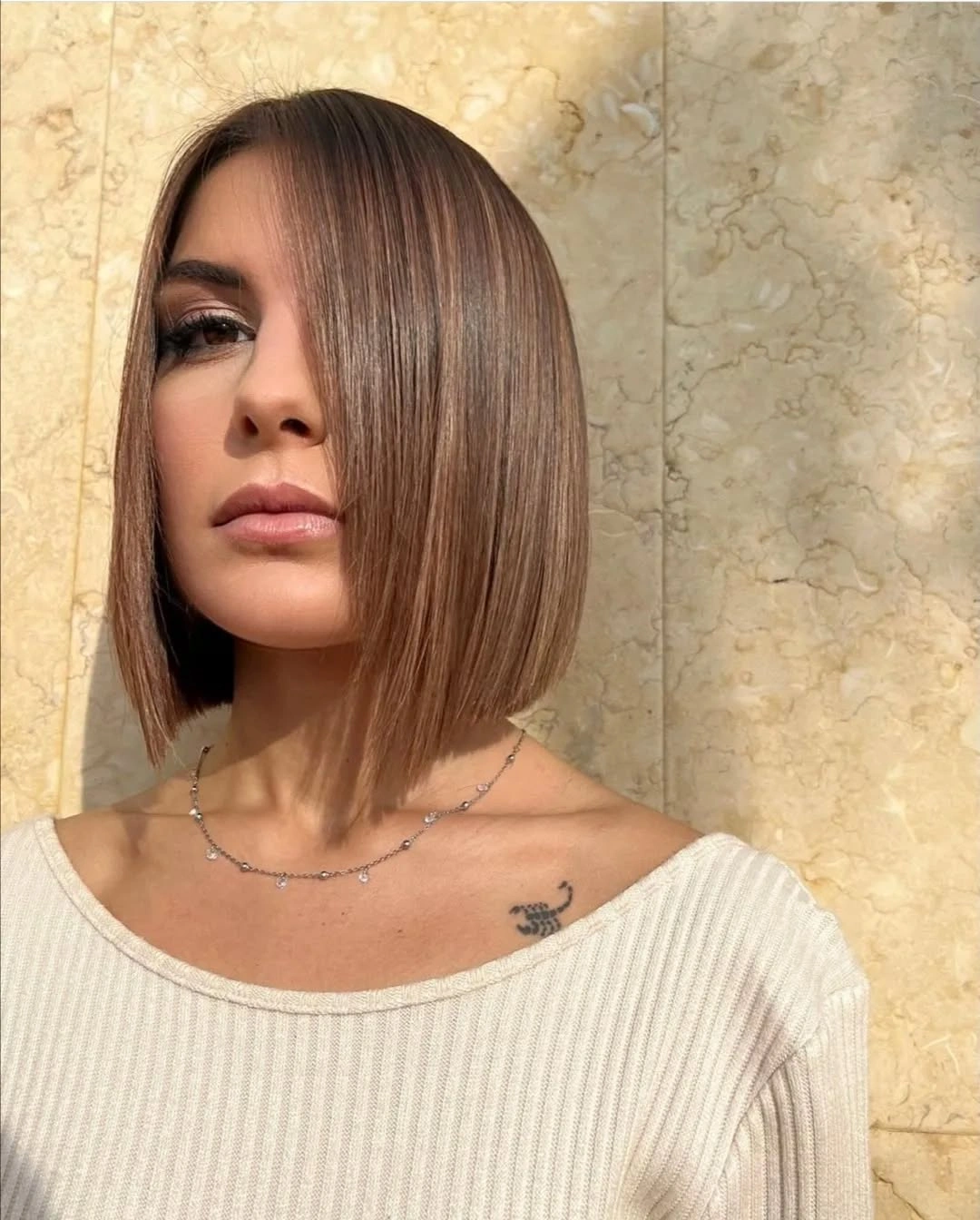 short bobbed hairstyle Elegant Angled Bob With Soft Mocha Shine
