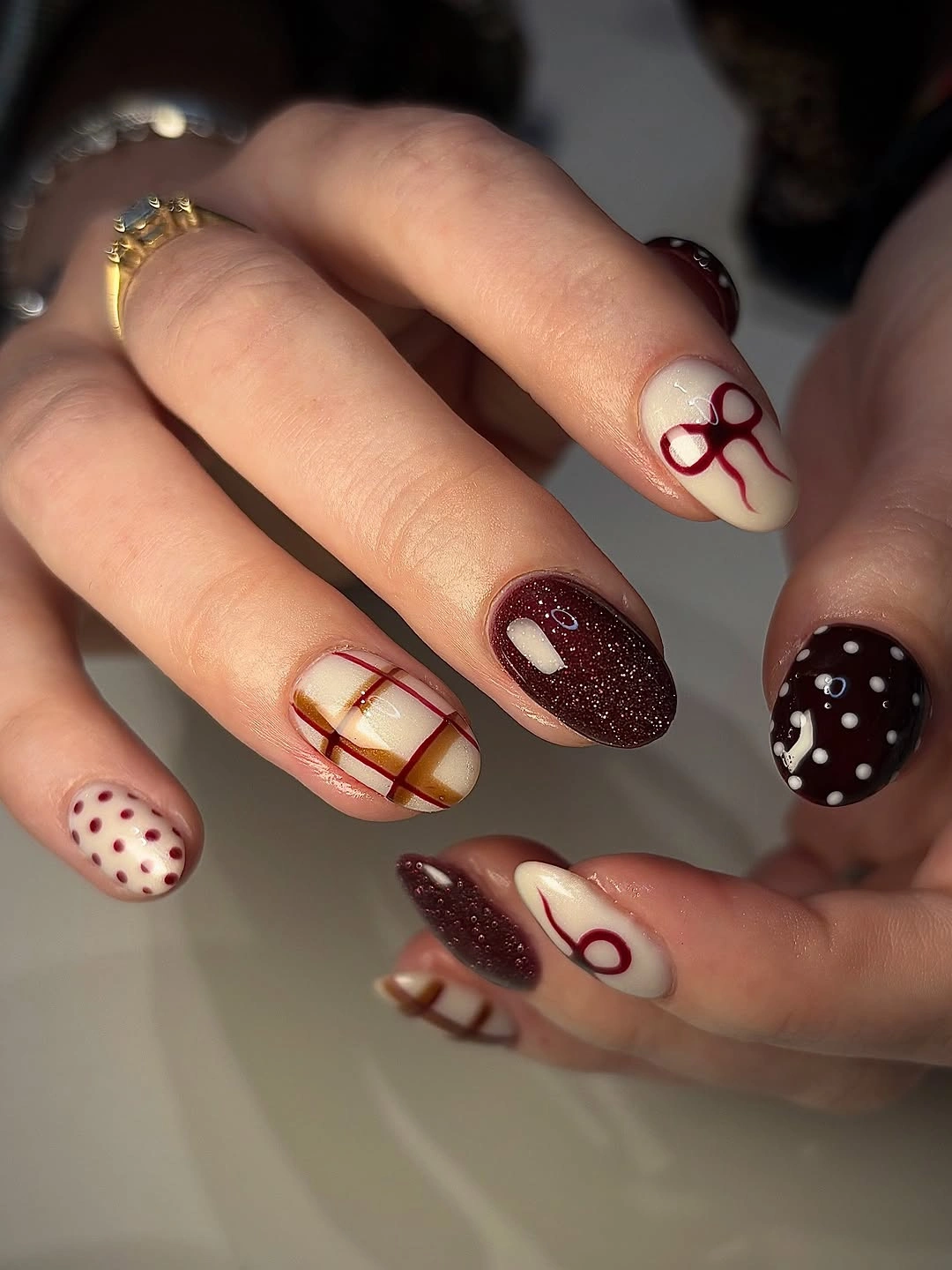Medium square brown glitter nails with cream and red-brown abstract loops