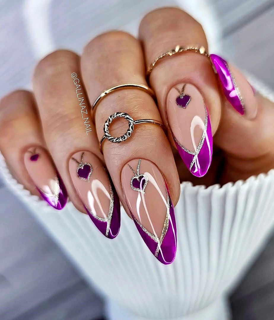 Long almond blush nails with plum tips, hearts, and gold lines