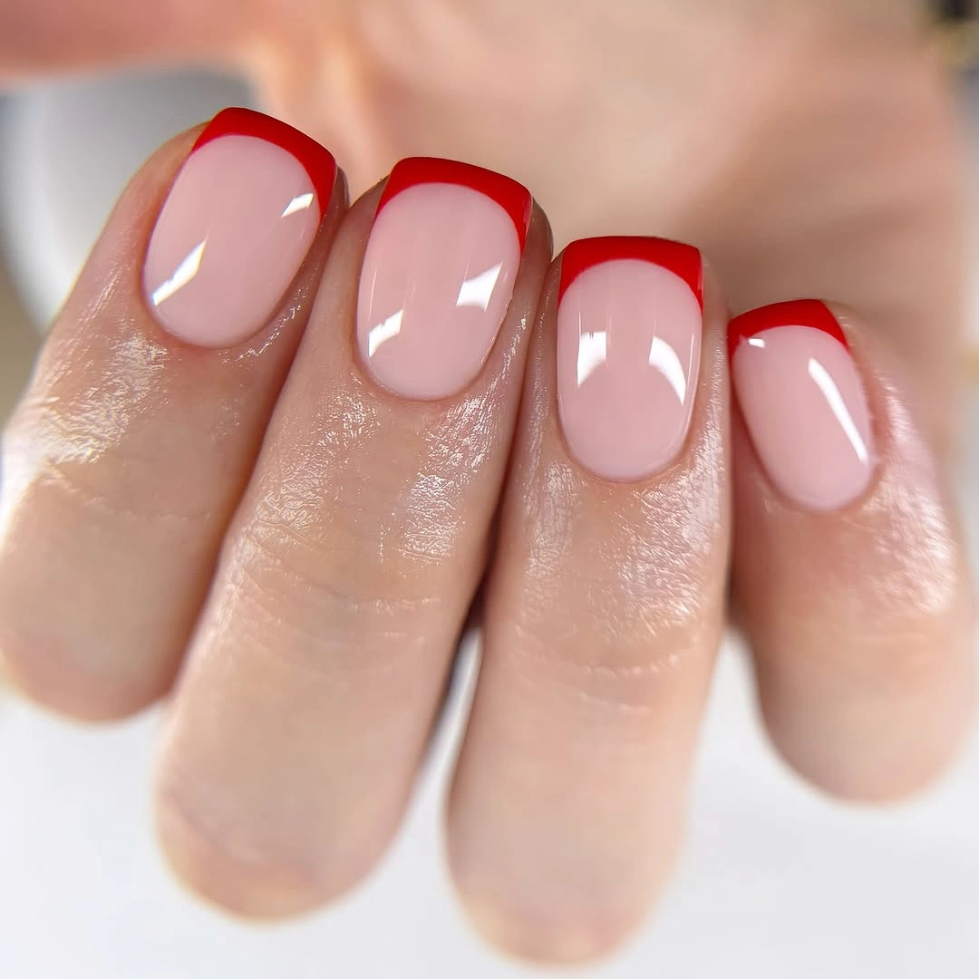 Short rounded nails in a glossy translucent milky pink