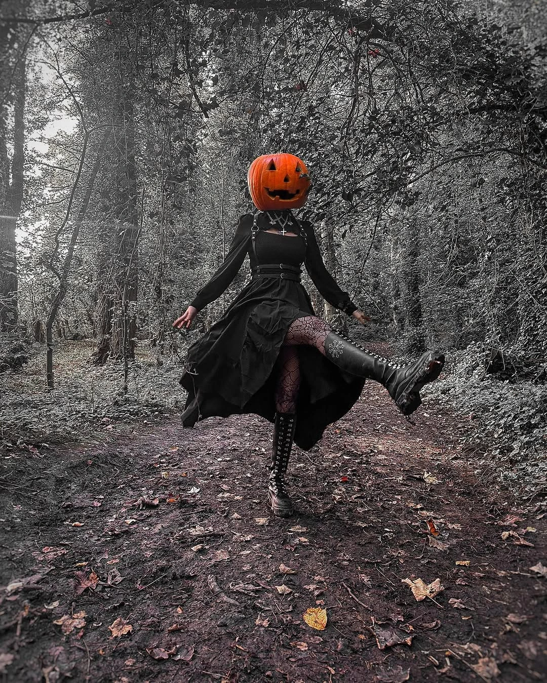 Jack-o'-lantern head costume with black ruffled skirt and tall boots