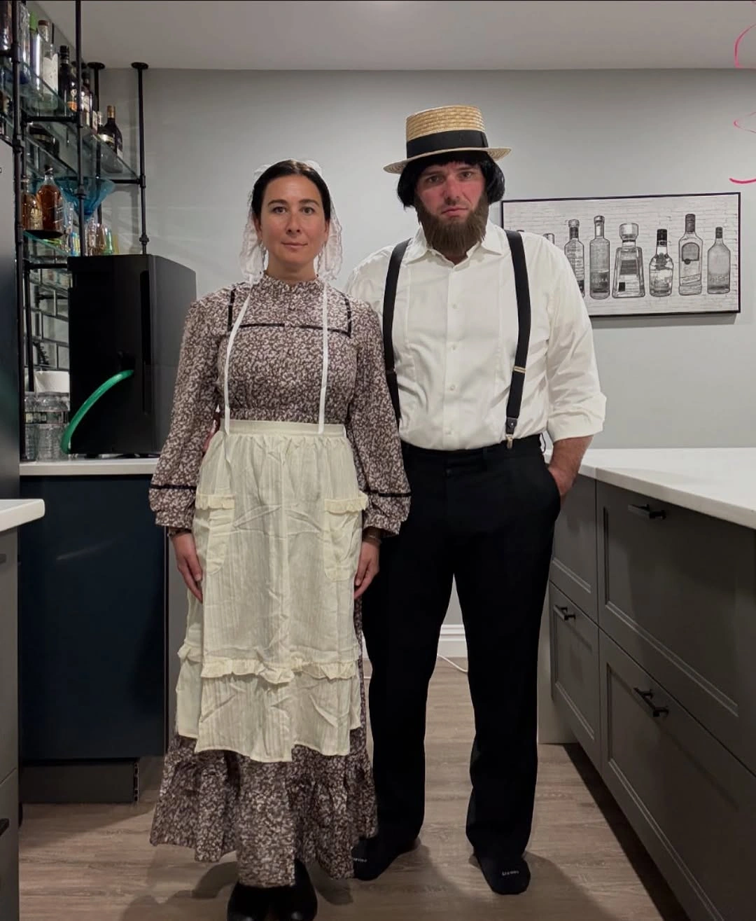 American Gothic prairie couple Halloween costumes with apron, suspenders, and straw hat