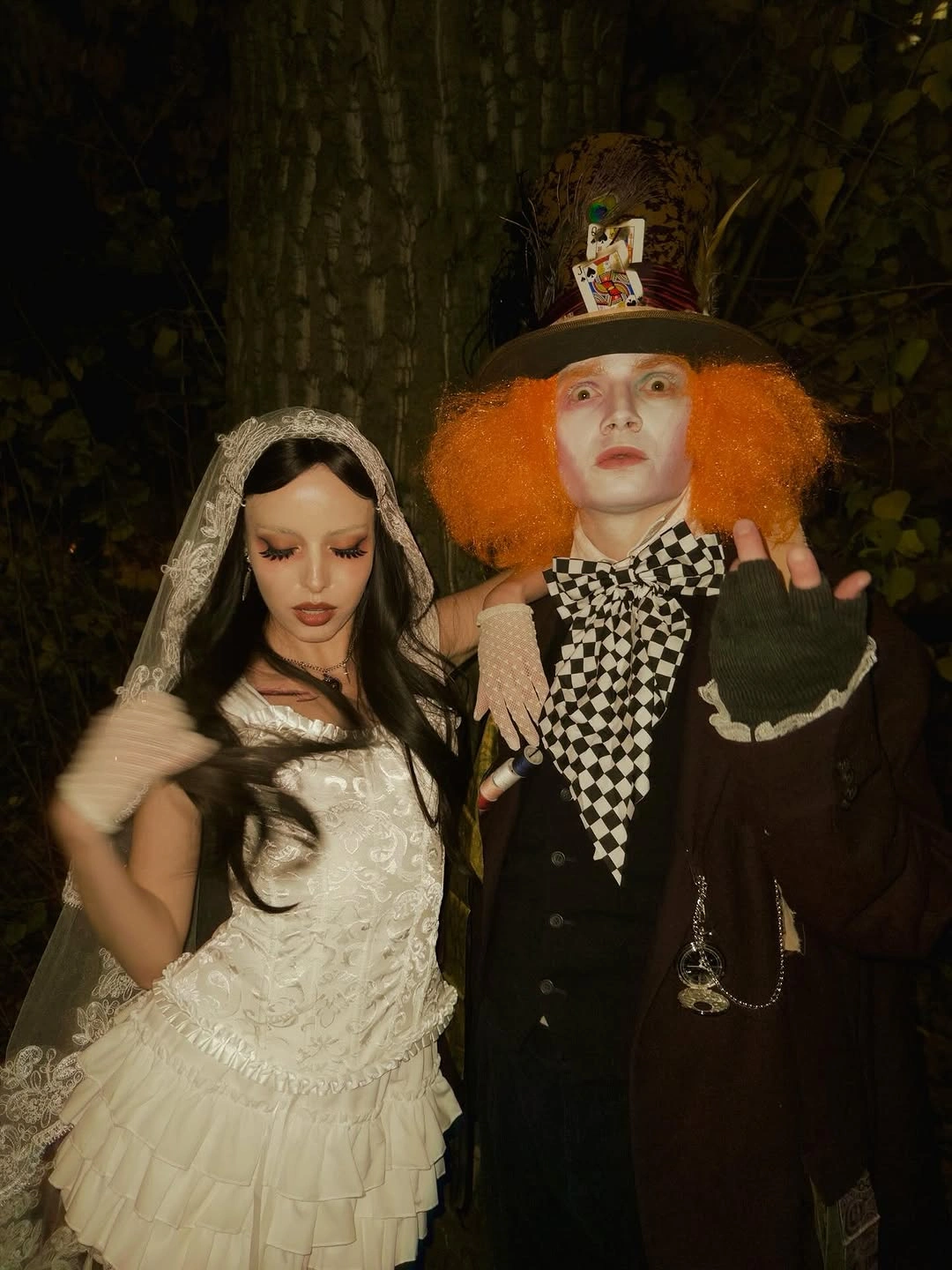 Corpse Bride Emily costume beside Mad Hatter costume at Halloween party