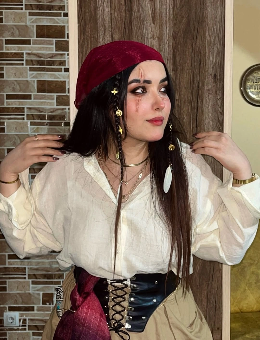 Classic pirate costume with billowy blouse, black corset, and red beret